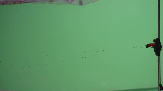 Slow motion blood squibs exploding, spraying blood across the screen on green screen. For use with visual effects and/or design and texturing.