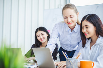 Fototapeta premium Young business woman working happy smile and relax in office