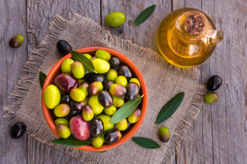 Fresh mixed olives on wooden table