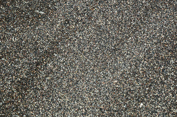 Black sand formed from the volcano and starfish for the texture,background and empty space for the text.
Beach sand in Greece