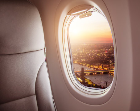 Fototapeta Airplane interior with window view of London city, Europe.