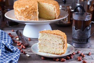 Homemade cake with cream on a wooden table
