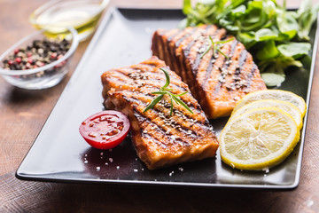 Grilled  salmon fillet with salad tomatoes and sesame
