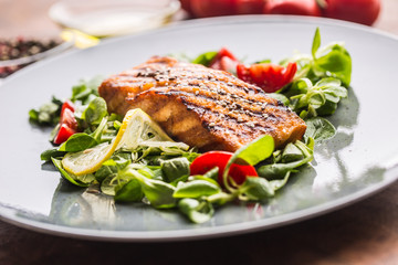 Grilled  salmon fillet with salad tomatoes and sesame