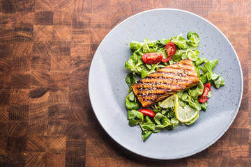 Grilled  salmon fillet with salad tomatoes and sesame