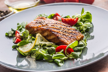Grilled  salmon fillet with salad tomatoes and sesame