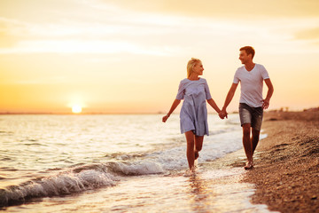 Young happy couple on seashore.