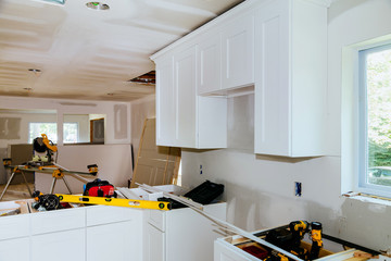 Custom kitchen cabinets in various stages of installation base for island in center