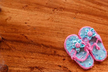 Baby Sandals on Wooden Background
