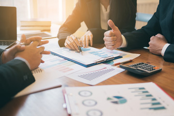 Business concepts,Business teamwork use a pen pointing at graph,Office worker using a tablet and secretary is taking notes,smart phones and graphs on the desk. Meeting in office.