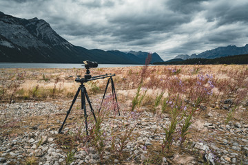 Timelapse slider setup with campera tripod across Isolated Peak and surrounding mountains and forests in Banff National Park in the Rocky Mountains in Alberta, Canada.