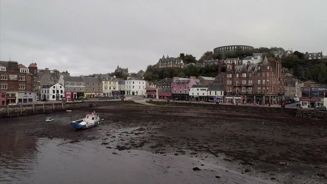 Flying Over a Bay Towards the Town of Oban in Scotland