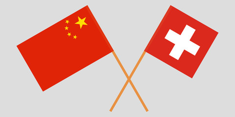 The crossed China and Switzerland flags. Official colors. Vector