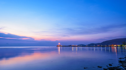 Fototapeta premium Beautiful natural landscape of the light reflecting the surface at Nathon Pier and boat on colorful sky twilight after sunset over the sea at Ko Samui island, Surat Thani, Thailand, 16:9 widescreen