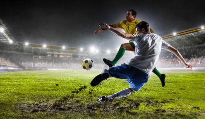 Fototapeta na wymiar Soccer players at stadium. Mixed media