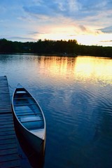 A sunset, a canoe, and a tranquil lake in Greenville, Michigan