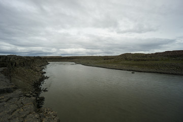 Iceland - Broad river before detifoss waterfall in stony area