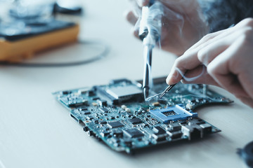 technology microelectronics science education. engineer student learning to solder an electronic...