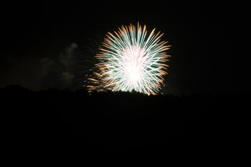 Fototapeta premium Two magic simultaneous fireworks explosions in white color