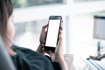 blank screen smartphone mock up.woman holding mobile phone with blank screen for insert graphic objects.chatting message with device.
