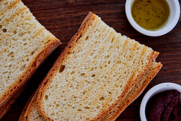 Gourmet Italian snack, restaurant menu ,food photo concept. Chef's olive tapenada and crunchy rye baguette in restaurant serving.