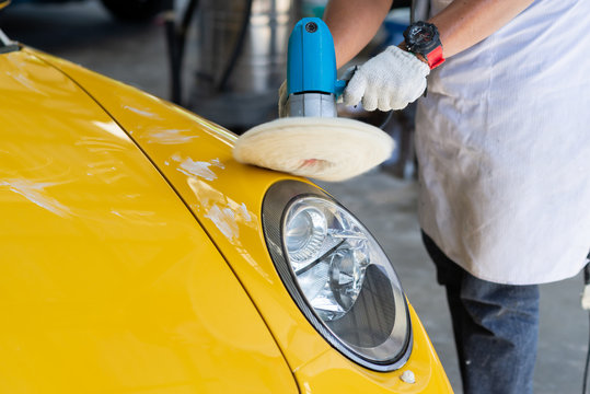 Fototapeta Car detailing series: Polishing yellow sports car fender