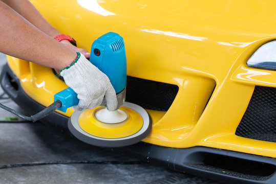 Fototapeta Car detailing series: Polishing yellow sports car