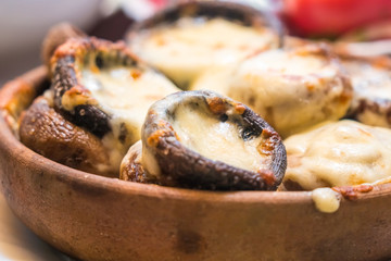 Stuffed mushrooms with cheese on the pot, Georgian cuisene