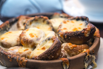 Stuffed mushrooms with cheese on the pot, Georgian cuisene