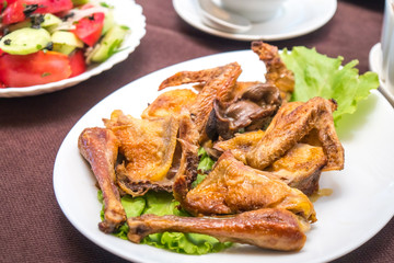Roasted chicken on the plate, Chicken Tabaka, Georgian cuisine