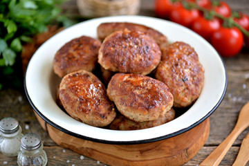 Homemade cutlets from minced pork and beef. Rustic food.