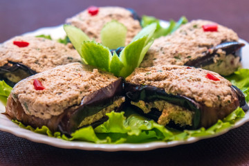 Roasted eggplants and peppers stuffed with nuts on a plate