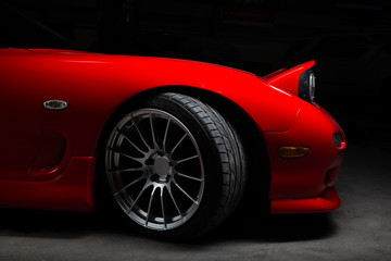 Obraz na płótnie Canvas Car detailing series: Closeup of clean red sports car