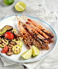 Grilled vegetables and prawns (shrimps) on bamboo skewers. Healthy food.