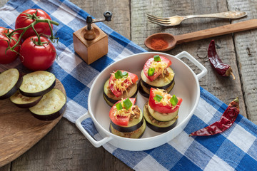 Slices of eggplant with minced meat, tomatoes and cheese ready for baking