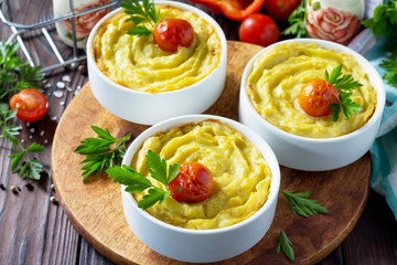 Thanksgiving Turkey dinner. Baked potatoes with turkey meat, potato casserole close-up on a wooden table. The concept of food on thanksgiving.