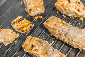 Slices of roasted salmon in a grill pan