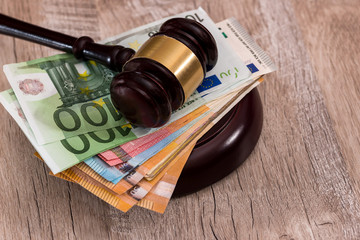 Judge's gavel on stack of euro banknotes