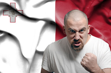 Angry man against flag of Malta
