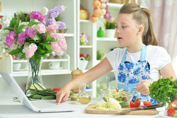Cute teen girl using laptop