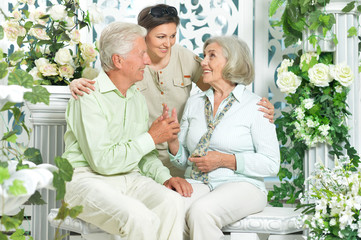 Fototapeta premium Portrait of happy senior couple with adult daughter