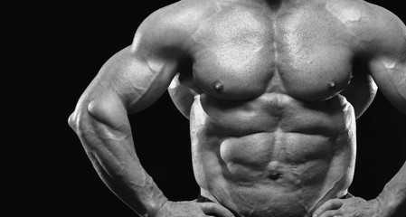 Close-up - Male fitness model with naked torso showing sixpack abdominal and muscular body.