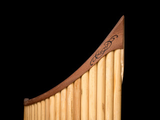 Pan flute in front of black background © Stefan