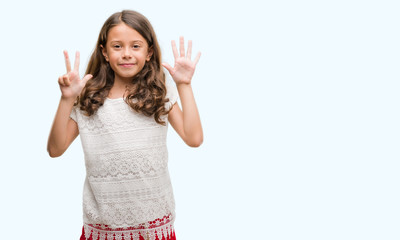 Brunette hispanic girl showing and pointing up with fingers number eight while smiling confident...