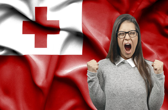 Ecstatic Woman Holidng Fists And Screaming Against Flag Of Tonga