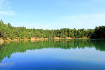 Fototapeta na wymiar Forest lake with blue water. Beautiful lake panorama