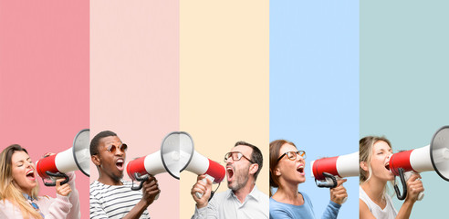 Mixed group of people, women and men communicates shouting loud holding a megaphone, expressing...