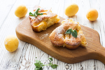 Two pieces of apricot homemade cake and fresh apricots