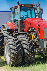 modern tractor for agriculture on the farm with a powerful motor, the flagship of the modern agricultural industry - 214509861