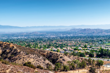 Southern California suburbs on summer morning with houses from mountains to desert